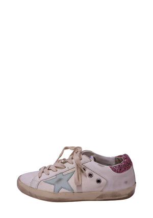 Authentic Golden Goose Super-Star white leather low-top sneakers featuring an ice blue leather star, pink glitter heel tab, distressed rubber sole, and lace-up