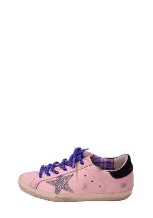 Authentic Golden Goose Superstar pink leather sneakers with a silver glitter star, blue laces, black heel tab, and distressed rubber sole.