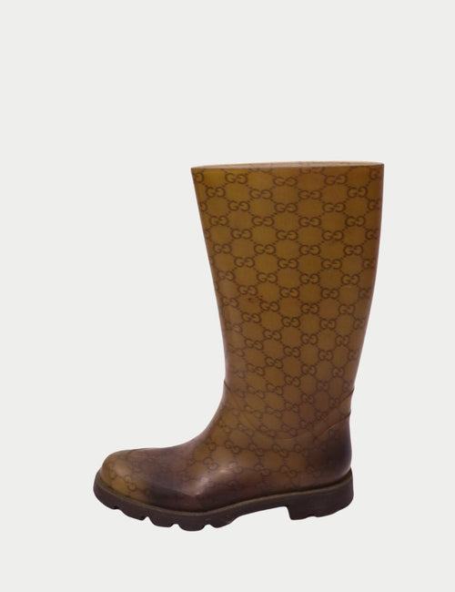 Brown Gucci rubber rain boot with all-over GG monogram pattern