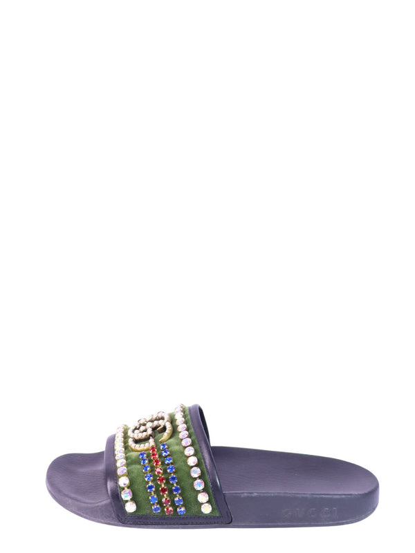 Gucci black slide sandals with crystal embellished straps and interlocking GG logo detailing.