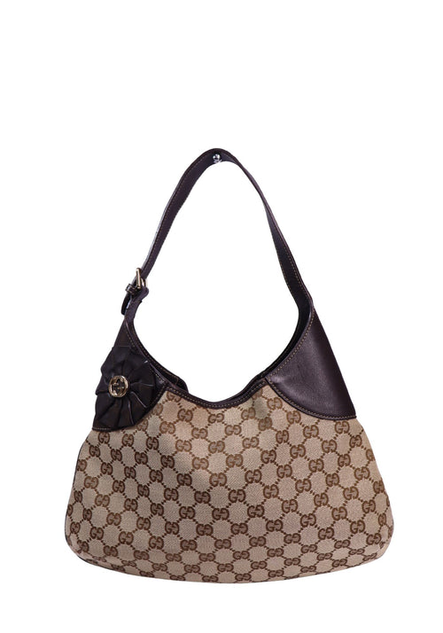Gucci beige and brown GG monogram canvas shoulder bag with dark brown leather trim, adjustable shoulder strap, and signature leather bow featuring the Interlocking G logo