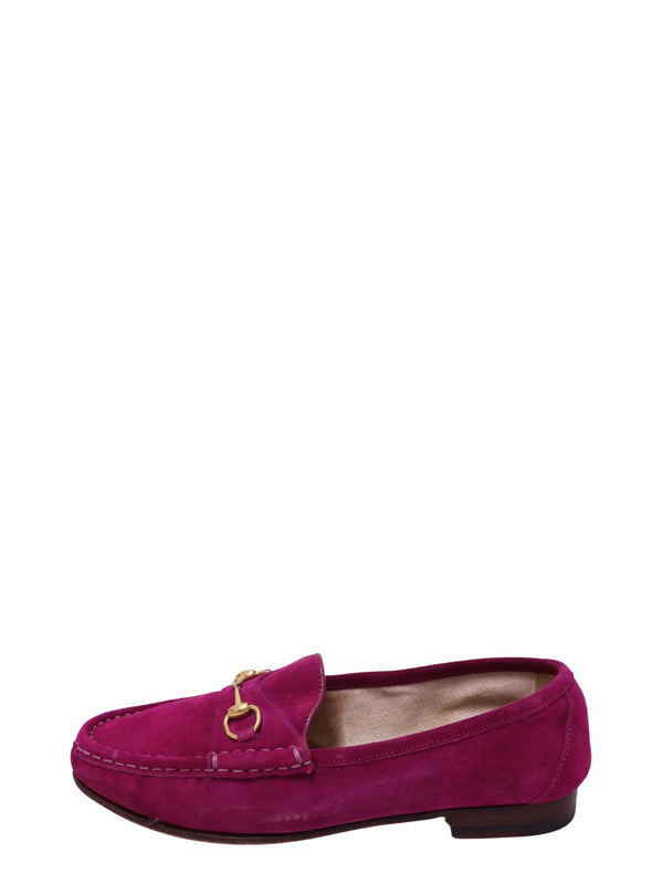 Authentic Gucci fuchsia suede loafers featuring signature gold-tone Horsebit hardware, moccasin stitching, and a classic slip-on silhouette