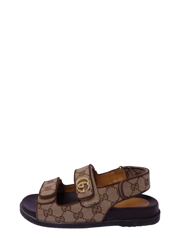 Gucci beige and brown GG monogram canvas sandals with gold Double G hardware, Velcro straps and black rubber sole