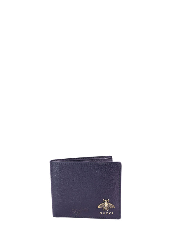 Gucci textured leather bifold wallet in dark navy with gold-tone bee logo detail on the front.