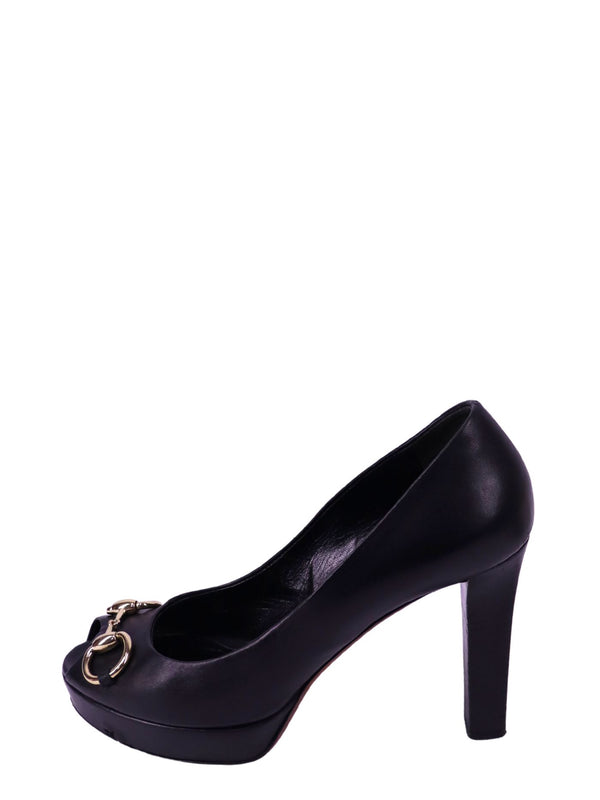 Gucci black leather platform pumps with gold-tone horsebit hardware and peep toe design.