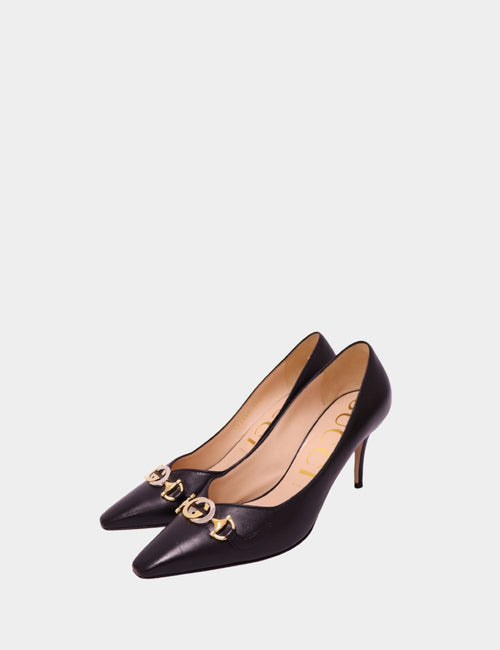 Black Gucci leather pointed toe pumps with gold GG logo chain and mid-height heel


