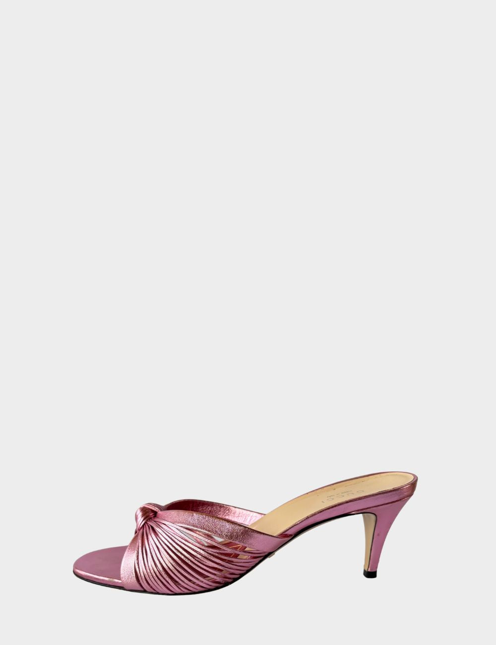 Step into feminine glamour with these Gucci metallic pink mules, designed with an elegant vintage-inspired silhouette. Featuring soft, knotted crossover straps, these slip-on heels are crafted from lustrous metallic leather that catches the light with eve Step into feminine glamour with these Gucci metallic pink mules, designed with an elegant vintage-inspired silhouette. Featuring soft, knotted crossover straps, these slip-on heels are crafted from lustrous metallic leather that catches the light with eve