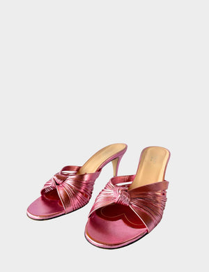 Gucci metallic pink leather mules with knotted crossover straps and low kitten heel.

