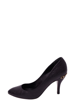 Gucci black Guccissima leather stiletto pump featuring an all-over embossed GG monogram pattern, almond-shaped toe, slender high heel, and small gold-tone horsebit-inspired accent near the heel