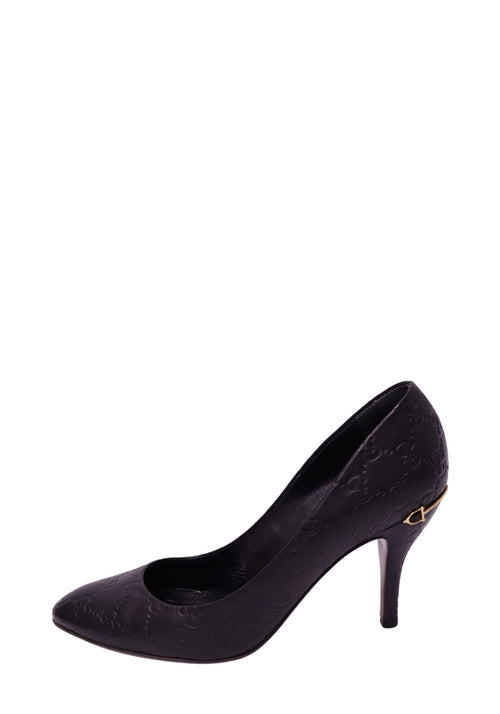 Gucci black Guccissima leather stiletto pump featuring an all-over embossed GG monogram pattern, almond-shaped toe, slender high heel, and small gold-tone horsebit-inspired accent near the heel
