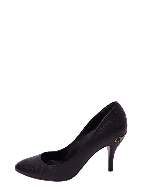Gucci black Guccissima leather stiletto pump featuring an all-over embossed GG monogram pattern, almond-shaped toe, slender high heel, and small gold-tone horsebit-inspired accent near the heel