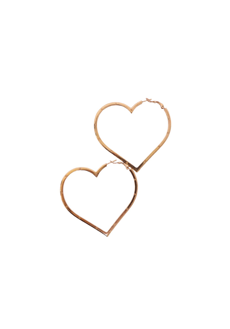 Pair of Chanel oversized gold-tone heart-shaped hoop earrings featuring polished open-heart metal silhouettes, subtle engraved detailing and hinged post closures