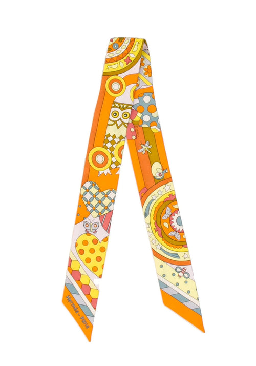 Hermès Les Murmures de la Forêt silk Twilly scarf featuring vibrant orange tones and whimsical forest-inspired motifs