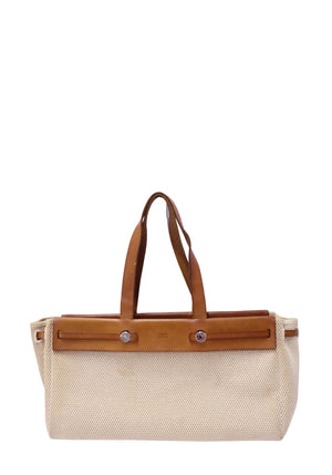 Authentic Hermès Herbag Cabas tote bag crafted from beige woven canvas with natural leather trim, dual top handles, signature leather strap closure, and palladium Clou de Selle hardware.