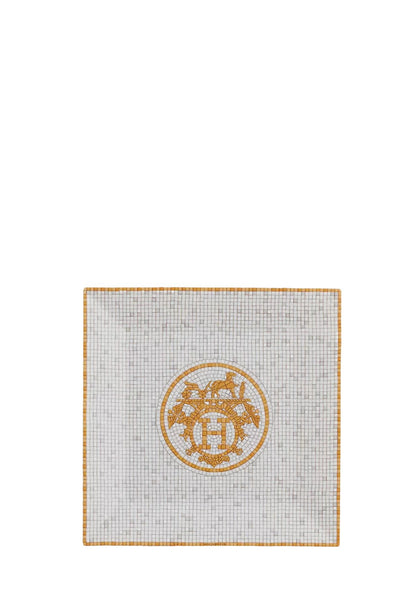 Hermès Mosaique au 24 gold porcelain square plate with mosaic pattern and central Hermès logo in white and gold tones.