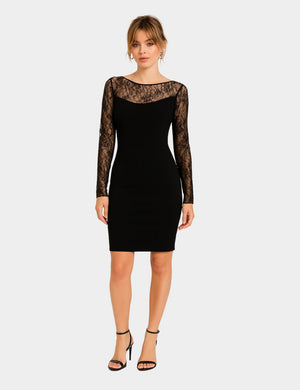 Model wearing black Hervé Léger mini dress with lace sleeves and illusion neckline

