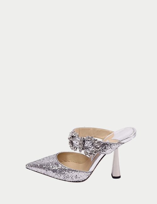 Silver Jimmy Choo pointed-toe mule heels with glitter finish, crystal-embellished strap, and sculptural high heel