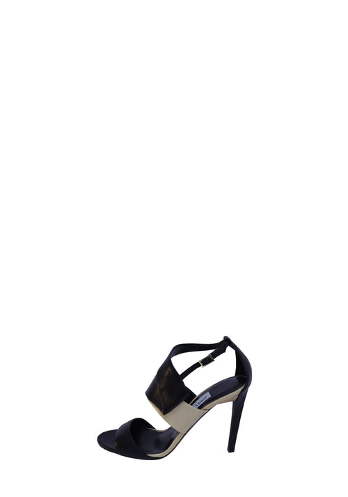 Jimmy Choo black and beige leather high heel sandals with wide crossover straps, open toe, adjustable ankle strap, and stiletto heels.