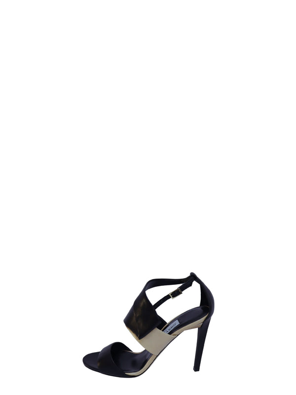 Jimmy Choo black and beige leather high heel sandals with wide crossover straps, open toe, adjustable ankle strap, and stiletto heels.