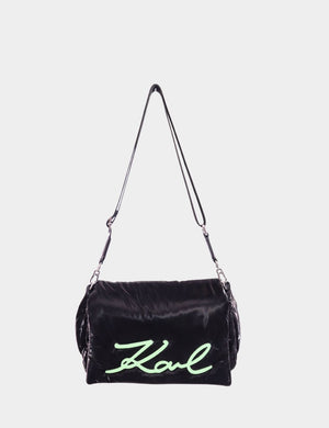 "Karl Lagerfeld black velvet pillow shoulder bag with neon green embroidered Karl signature, displayed on white background."

