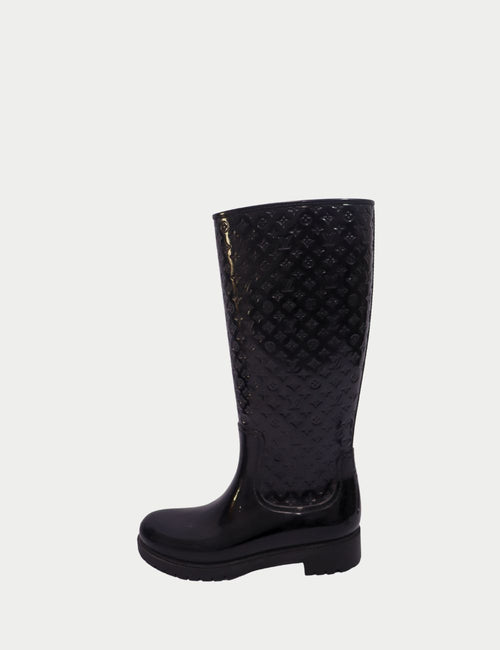 Louis Vuitton black monogram rain boots with knee-high design, glossy finish, and chunky rubber sole