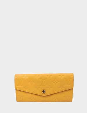 Louis Vuitton yellow Monogram Empreinte leather long wallet with snap button closure.
