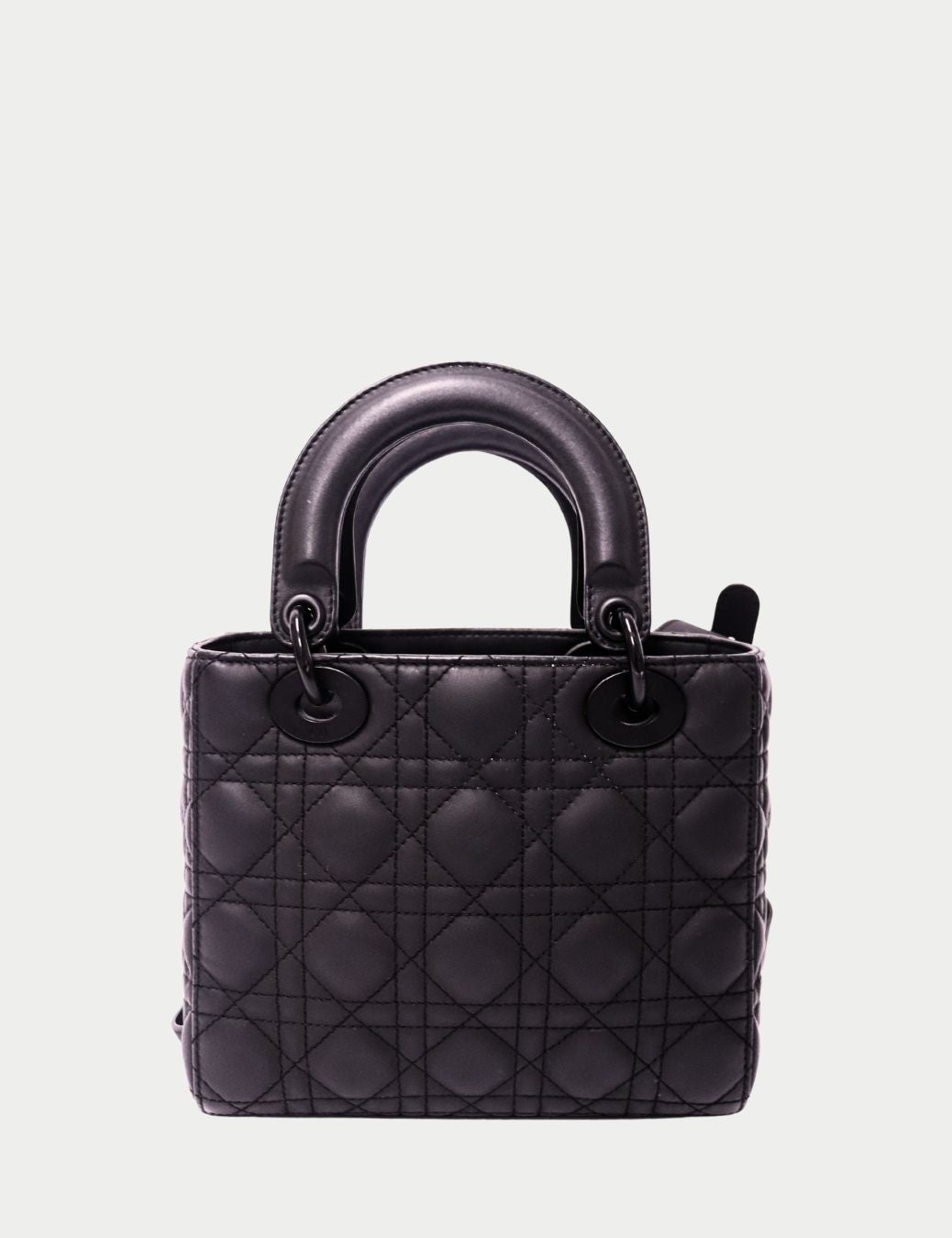 Iconic and timeless, this Christian Dior Lady Dior Bag in black lambskin is a true symbol of elegance and craftsmanship. Designed with Dior’s signature Cannage quilted stitching, this structured handbag is instantly recognizable.
It features dual rolled l Iconic and timeless, this Christian Dior Lady Dior Bag in black lambskin is a true symbol of elegance and craftsmanship. Designed with Dior’s signature Cannage quilted stitching, this structured handbag is instantly recognizable.
It features dual rolled l