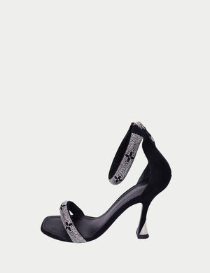 Black open-toe high-heel sandals by Louis Vuitton featuring crystal-embellished straps with monogram detailing, ankle strap closure, and sculpted heel