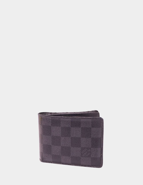 Louis Vuitton Damier Graphite bifold wallet in black and grey canvas with signature checkered pattern, angled view on plain background