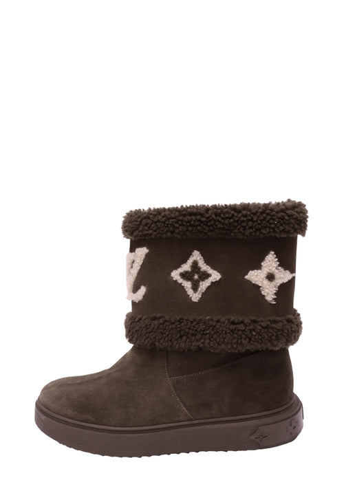 Louis Vuitton chocolate brown suede winter boot featuring cream LV Monogram embroidery, plush brown shearling-style trim, rounded toe, and chunky rubber sole with embossed Monogram flowers