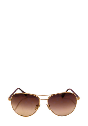 Authentic Louis Vuitton Conspiration pilot sunglasses with a gold-tone metal frame, tortoiseshell temples, and brown gradient lenses.