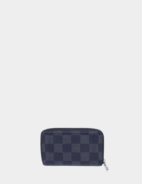 "Louis Vuitton Damier Graphite Zippy Coin Purse with silver zipper on white background."

