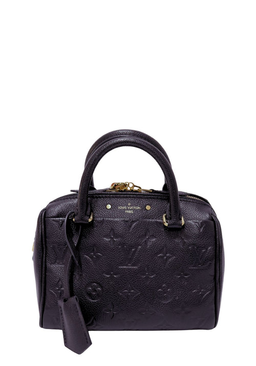 Louis Vuitton black Monogram Empreinte leather Speedy Bandoulière handbag featuring embossed Monogram pattern, rolled top handles, gold-tone hardware, top zip closure, removable leather clochette, and a structured silhouette