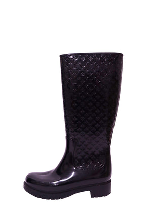 Louis Vuitton black knee-high rain boots with embossed Monogram pattern and chunky sole