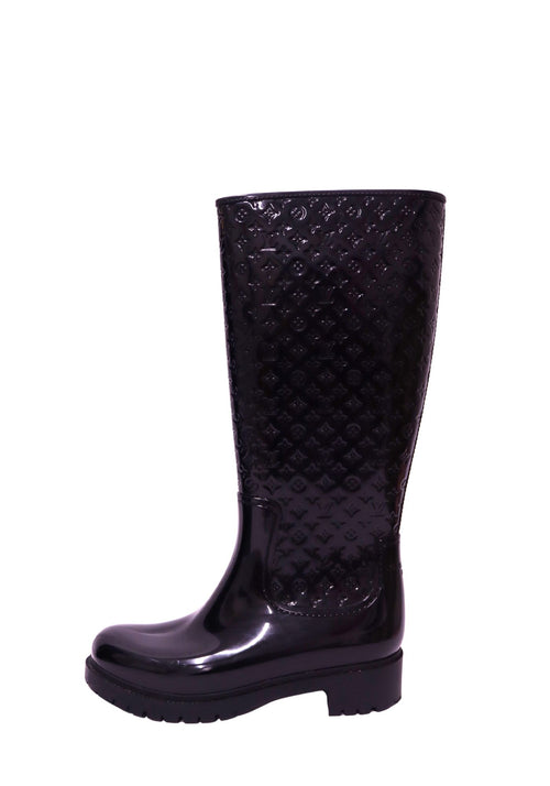 Louis Vuitton black knee-high rain boots with embossed Monogram pattern and chunky sole
