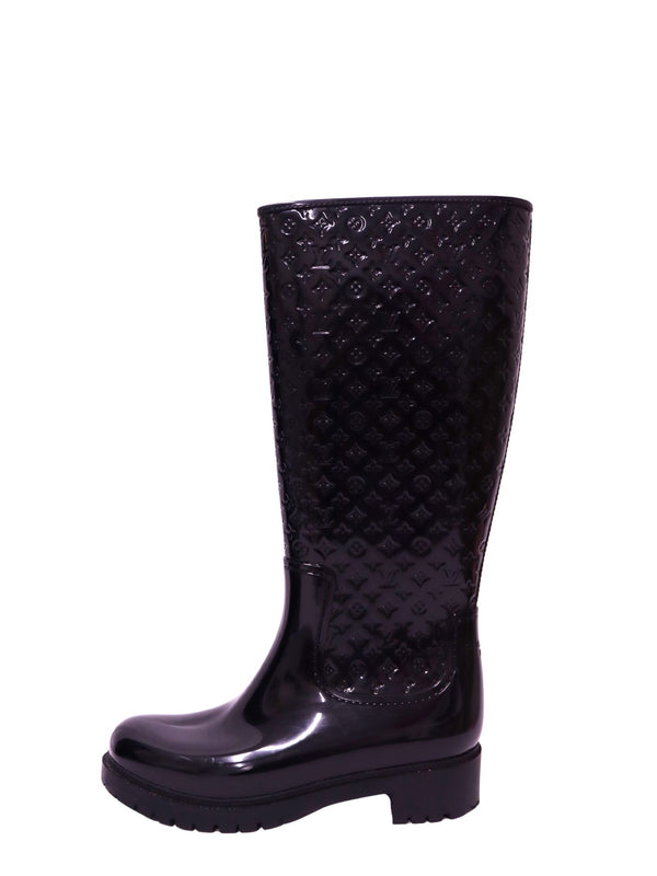 Louis Vuitton black knee-high rain boots with embossed Monogram pattern and chunky sole