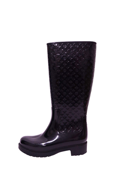 Louis Vuitton black knee-high rain boots with embossed Monogram pattern and chunky sole