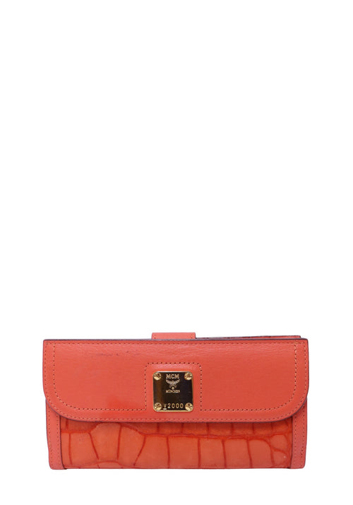 Authentic MCM orange croc-embossed leather continental wallet featuring a gold-tone logo plaque, flap closure, and slim silhouette