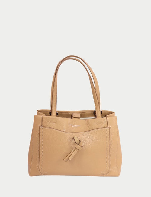 Camel pebbled leather tote handbag by Marc Jacobs featuring dual top handles, front knotted leather detail, and structured silhouette