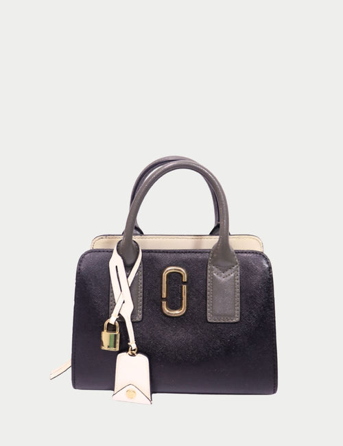 Marc Jacobs colorblock leather handbag with black, grey, and beige panels, gold-tone hardware, and lock charm
