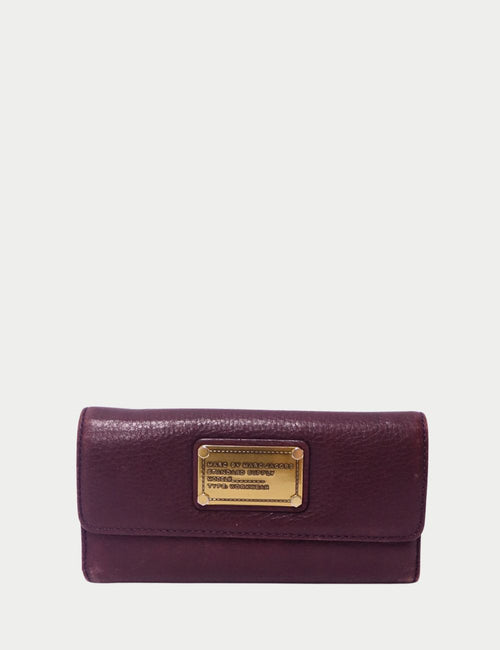 Marc by Marc Jacobs burgundy leather wallet with gold-tone logo nameplate on the front flap