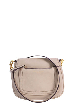 Marc Jacobs cream pebbled leather crossbody bag featuring a structured saddle silhouette, front slip pocket, gold-tone hardware