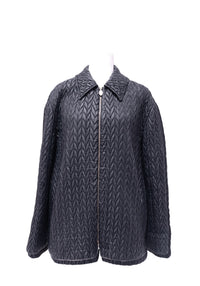 Max Mara black quilted jacket featuring an all-over elongated diamond chevron pattern, structured pointed collar, long sleeves and full-length silver-tone zipper