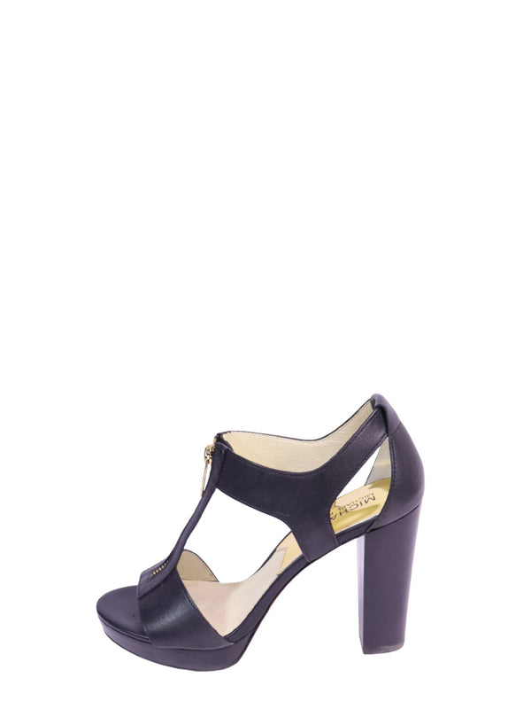 Michael Kors black leather platform sandals with front zip closure, open toe, cutout design, and block heel.