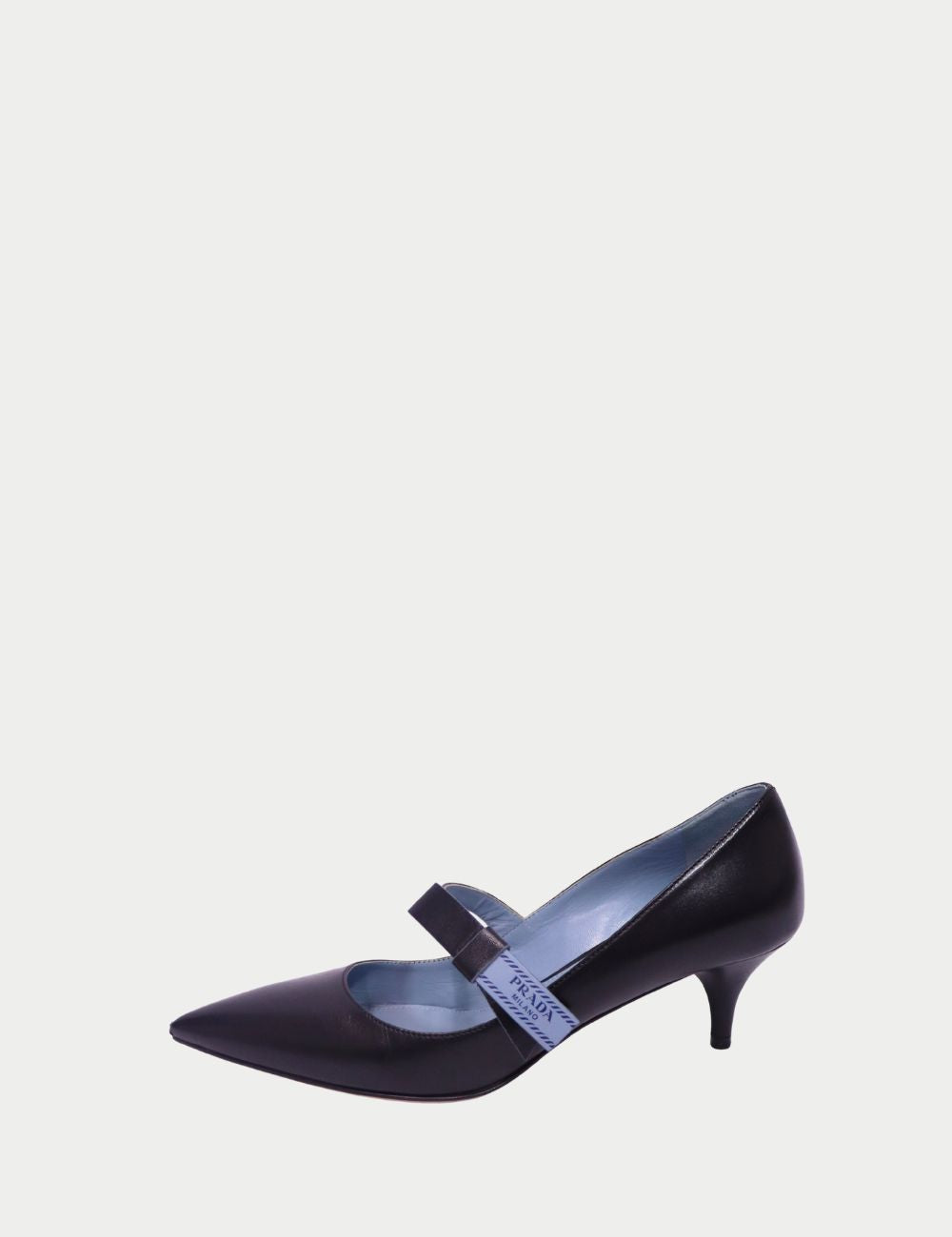 Exude elegance with these Prada Mary Jane pumps, crafted in smooth black leather with a sleek pointed toe and slim mid-height heel. Featuring a modern strap across the instep with Prada Milano logo detailing, these heels combine timeless sophistication wi