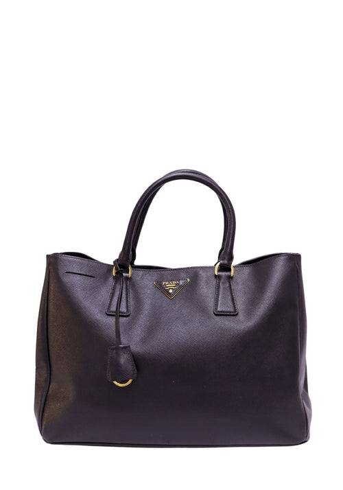 Prada Saffiano Lux black leather tote bag with gold-tone hardware and triangle logo
