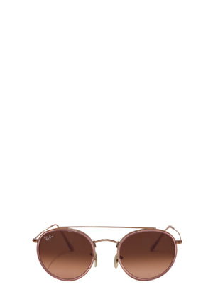 Authentic Ray-Ban gold-tone round sunglasses featuring a lightweight metal frame, soft pink gradient lenses, adjustable nose pads, and a timeless vintage-inspired silhouette.