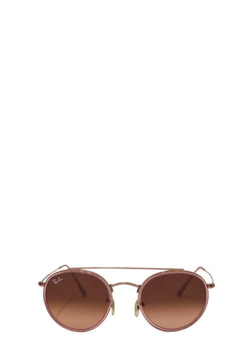 Authentic Ray-Ban gold-tone round sunglasses featuring a lightweight metal frame, soft pink gradient lenses, adjustable nose pads, and a timeless vintage-inspired silhouette.