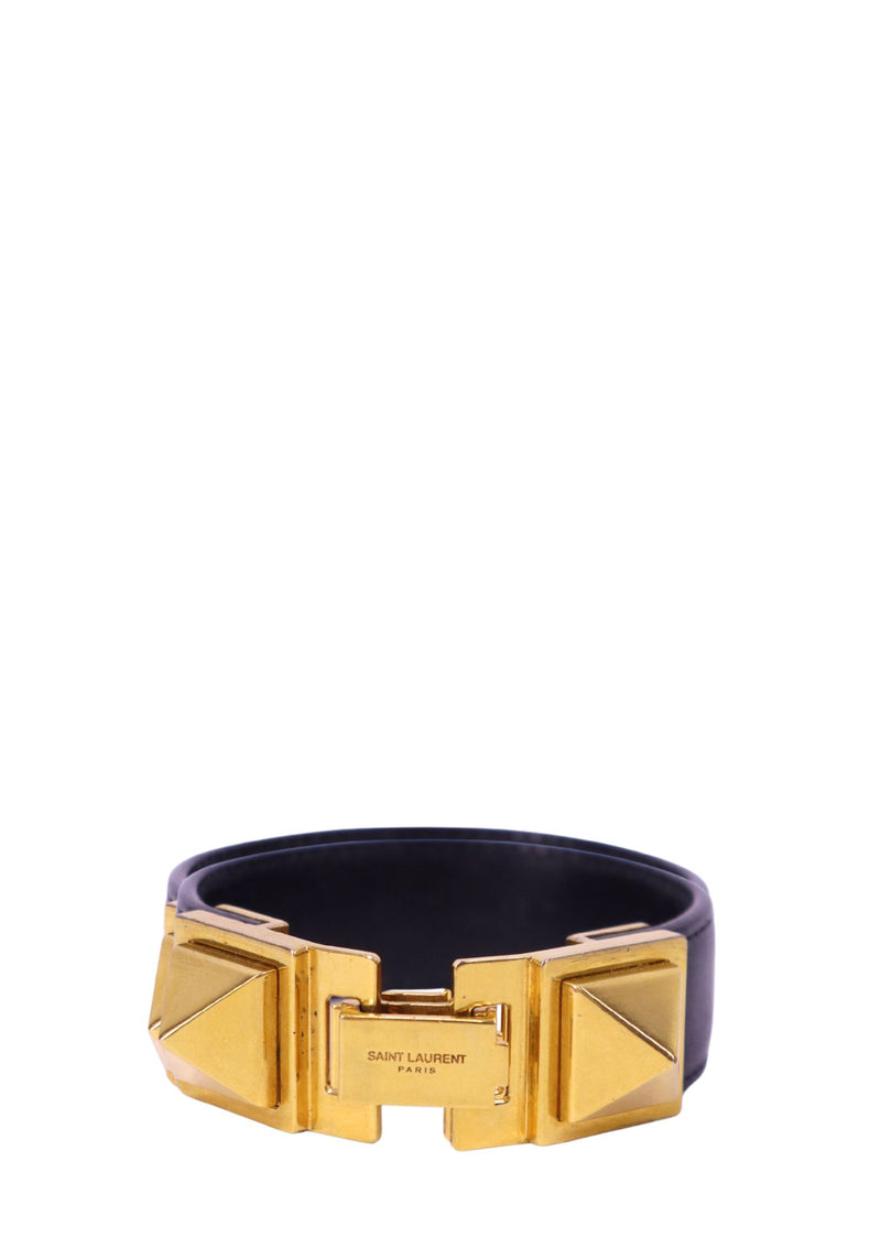 Saint Laurent black leather cuff bangle with gold-tone geometric hardware and engraved logo detail.