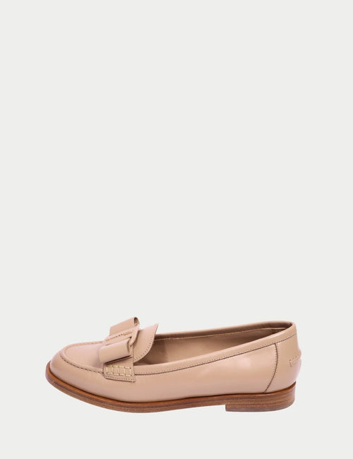 Beige leather loafers by Salvatore Ferragamo featuring classic penny-style vamp, stitched detailing, and low stacked heel